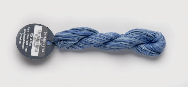 Blue skein of yarn with a label on a white background